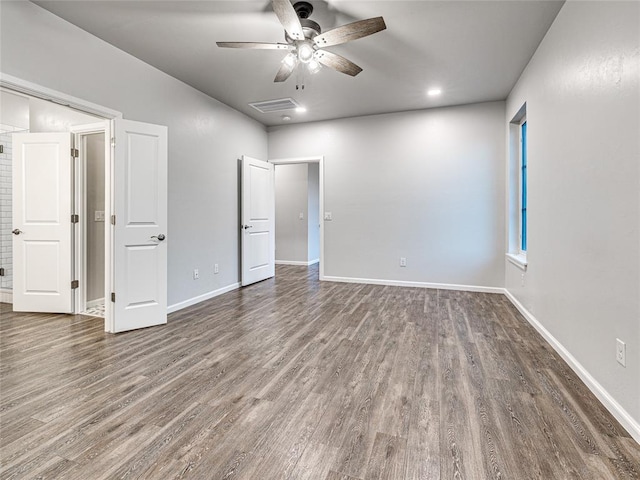 unfurnished room with ceiling fan and dark hardwood / wood-style floors