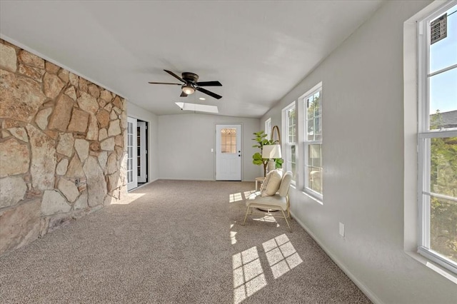 unfurnished sunroom with ceiling fan and lofted ceiling