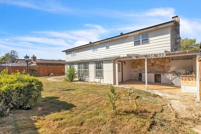 back of property featuring a lawn and a patio