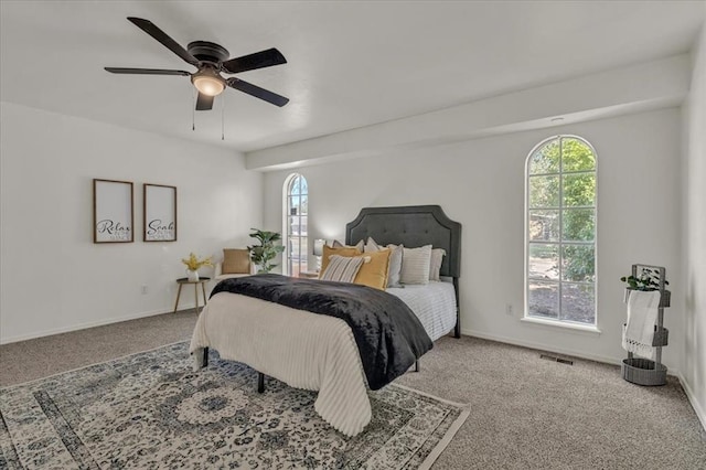 carpeted bedroom with multiple windows and ceiling fan