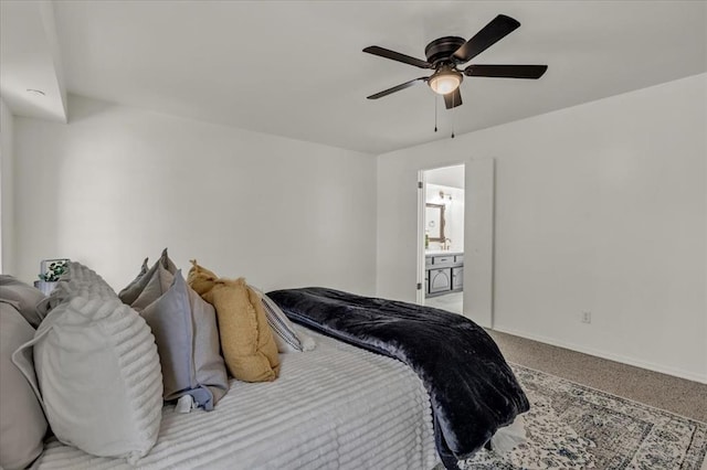 carpeted bedroom with ceiling fan and connected bathroom