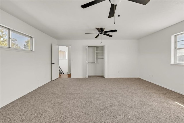 unfurnished bedroom featuring ceiling fan and carpet