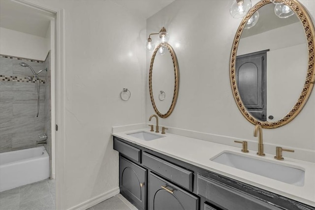 bathroom with tile patterned flooring, vanity, and tiled shower / bath