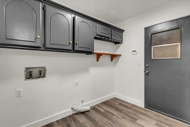 washroom with cabinets, electric dryer hookup, gas dryer hookup, hookup for a washing machine, and hardwood / wood-style flooring