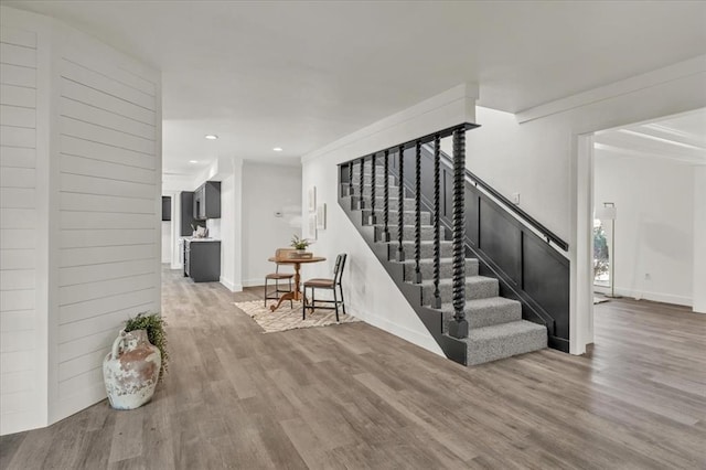 stairway featuring wood-type flooring