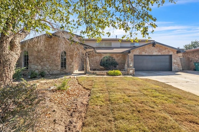 view of front of house with a front yard and a garage