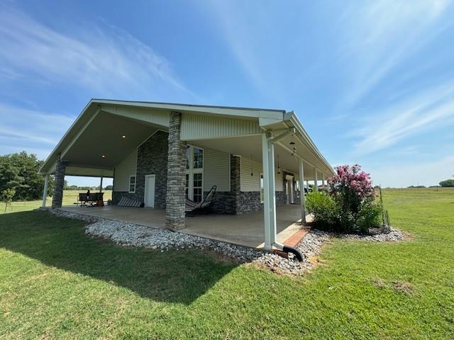 view of property exterior featuring a lawn and a carport