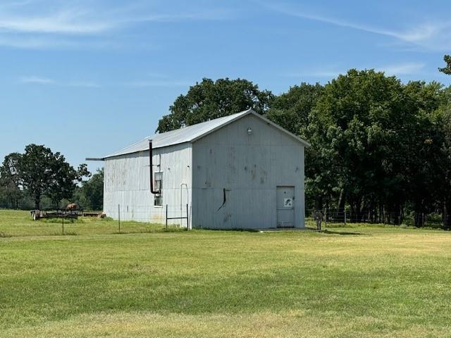 view of outbuilding with a lawn