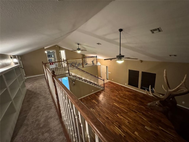 interior space featuring dark hardwood / wood-style flooring, ceiling fan, and lofted ceiling