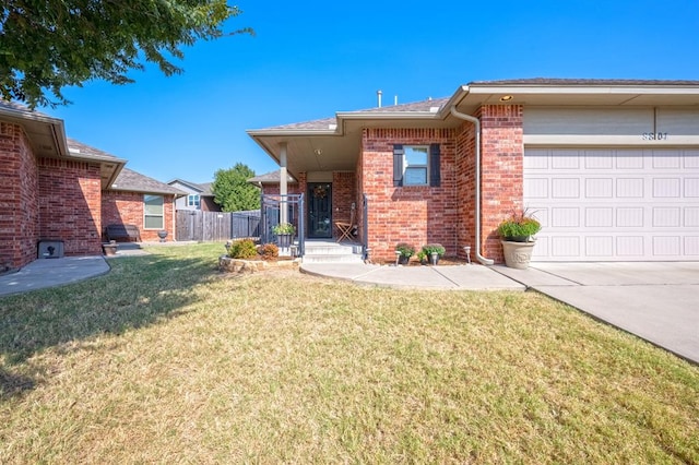 view of front of house featuring a garage and a front lawn