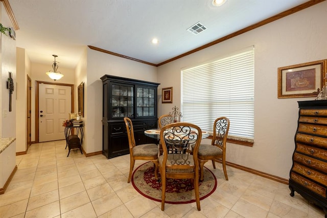 dining area featuring light tile patterned floors and crown molding