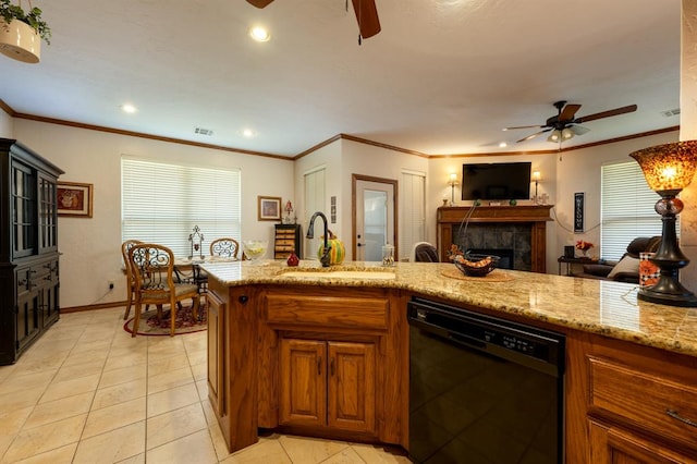 kitchen with dishwasher, sink, crown molding, a fireplace, and light tile patterned flooring