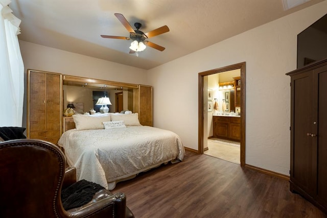 bedroom with hardwood / wood-style floors, ceiling fan, and connected bathroom