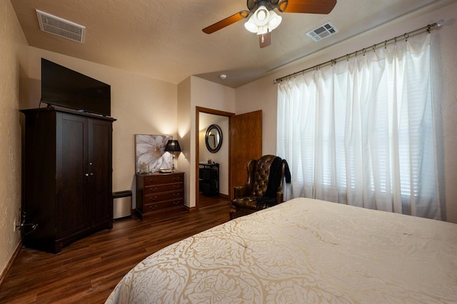 bedroom featuring multiple windows, ceiling fan, and dark hardwood / wood-style floors