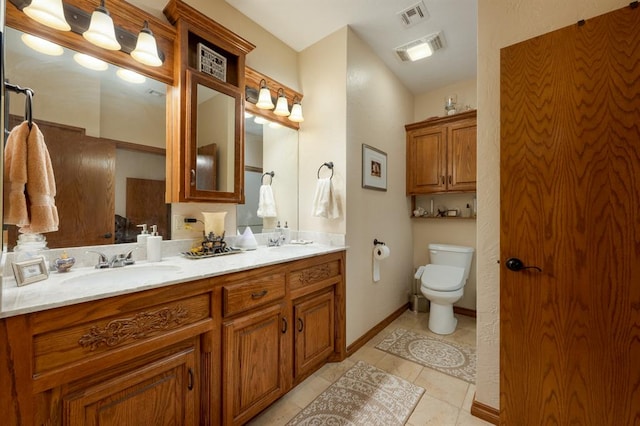 bathroom featuring tile patterned flooring, vanity, and toilet