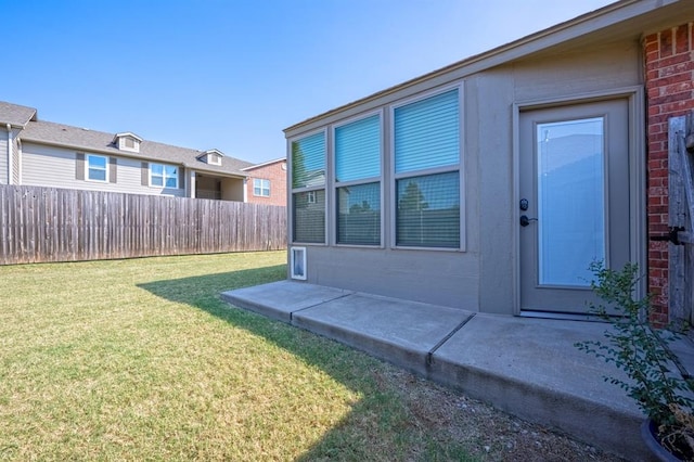 doorway to property featuring a yard