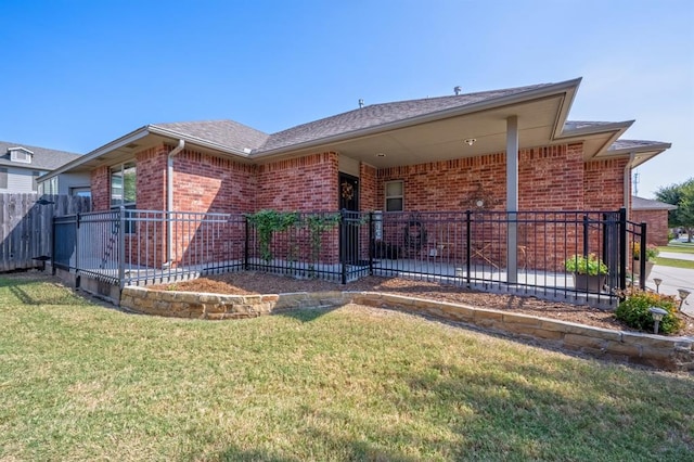 rear view of house featuring a yard