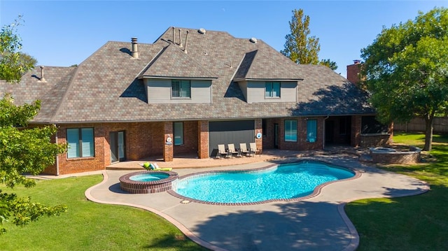 rear view of house featuring a lawn, a patio, and a pool with hot tub