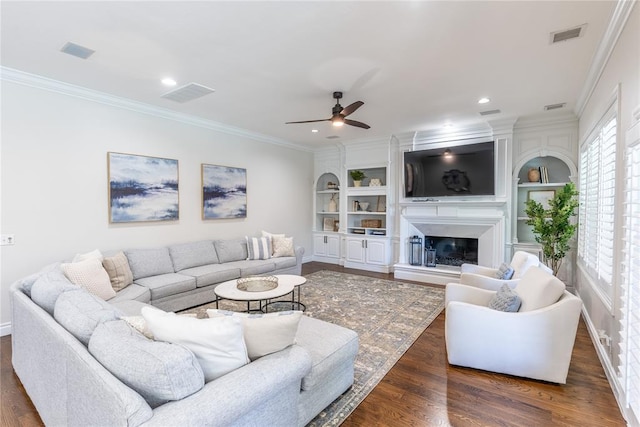 living room with dark hardwood / wood-style flooring, ceiling fan, and ornamental molding