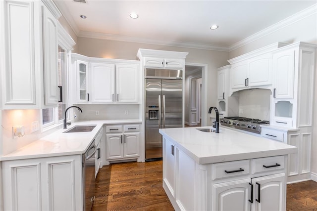 kitchen with sink, an island with sink, and stainless steel appliances