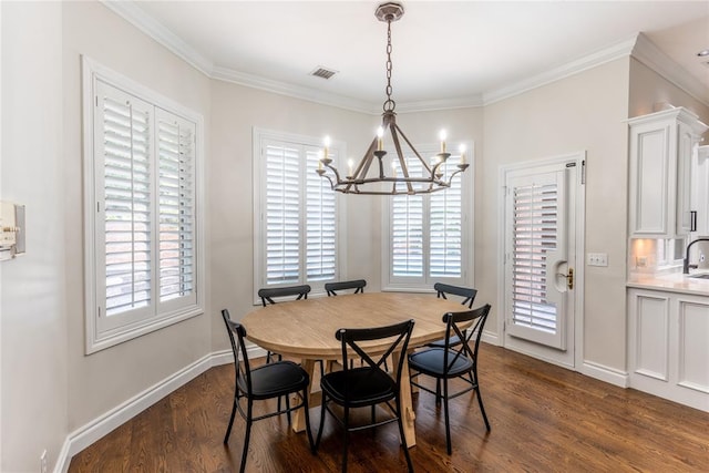 dining room featuring dark hardwood / wood-style floors, a healthy amount of sunlight, and ornamental molding