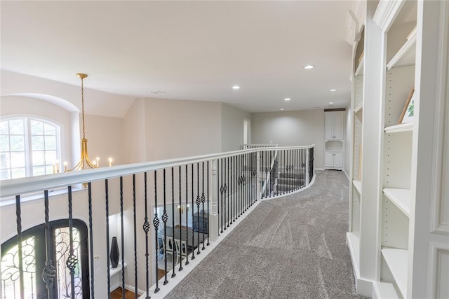 hall featuring carpet, french doors, and an inviting chandelier