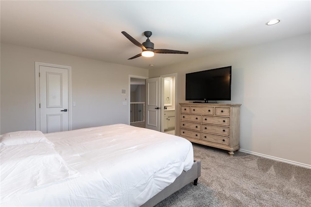 carpeted bedroom featuring ensuite bath and ceiling fan