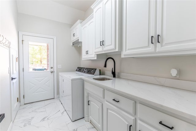 washroom featuring cabinets, sink, and washing machine and clothes dryer