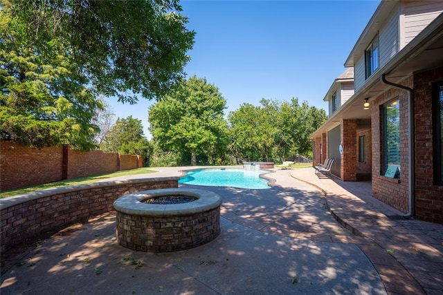 view of pool featuring a fire pit and a patio area