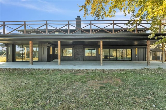 rear view of property with a lawn