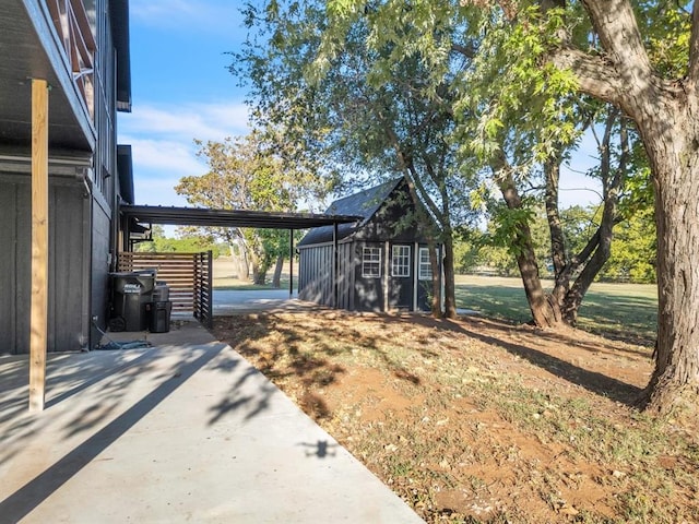 view of yard featuring an outbuilding and a patio