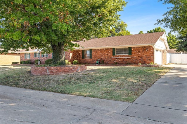 single story home with a front lawn and a garage