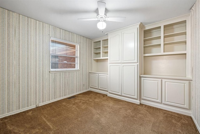 unfurnished room featuring carpet floors and ceiling fan