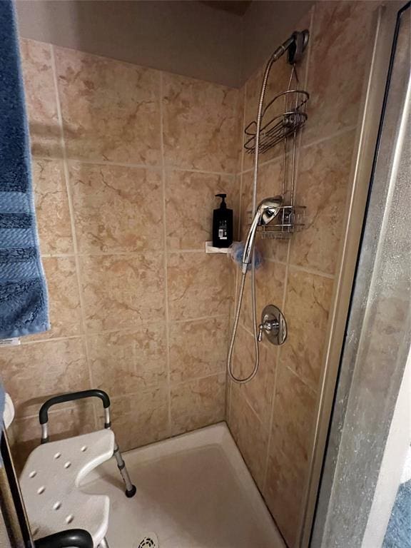 bathroom with a tile shower