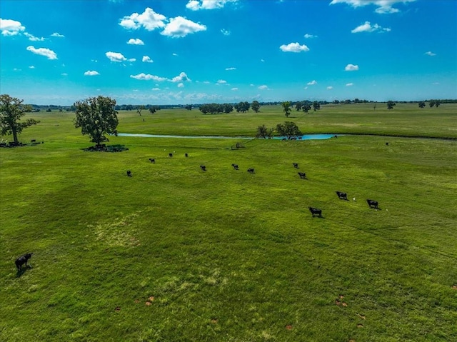 exterior space with a rural view and a water view