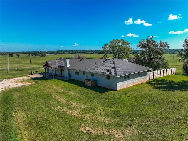 exterior space with a rural view and a lawn