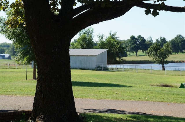 view of yard with a water view and an outdoor structure