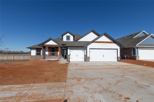 craftsman inspired home featuring a garage and covered porch