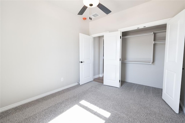 unfurnished bedroom featuring carpet floors, a closet, and ceiling fan