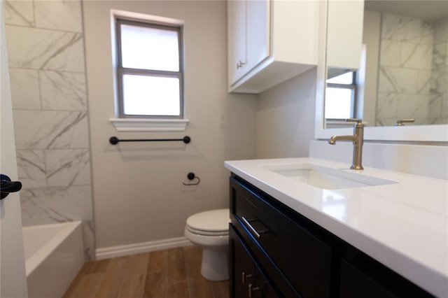 bathroom with vanity, toilet, and wood-type flooring