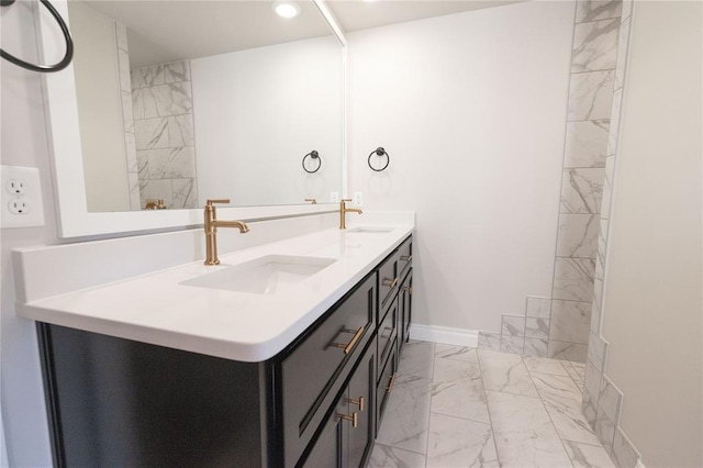bathroom featuring a sink, double vanity, marble finish floor, and recessed lighting