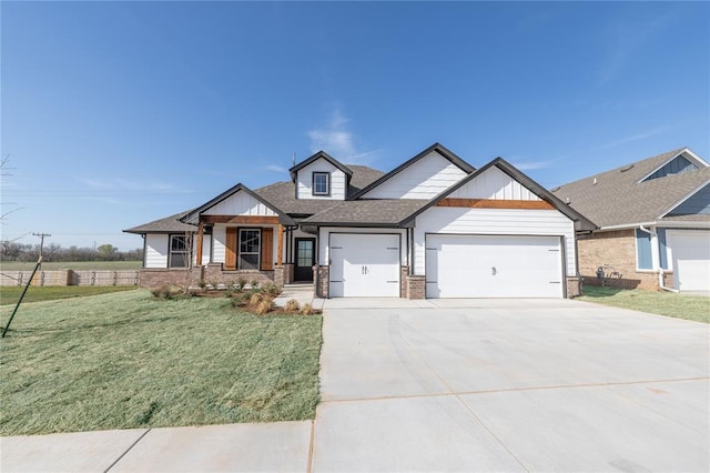 view of front of house with roof with shingles, a front yard, brick siding, a garage, and driveway