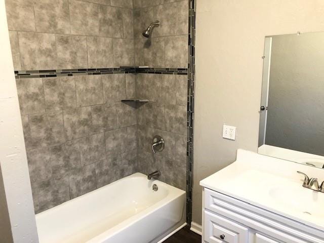 bathroom featuring vanity and tiled shower / bath combo