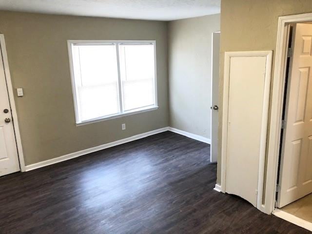 spare room featuring dark hardwood / wood-style flooring