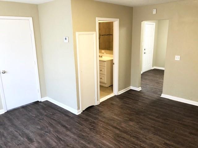 spare room featuring dark wood-type flooring