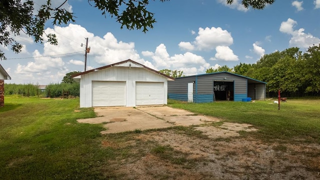 garage with a carport and a yard