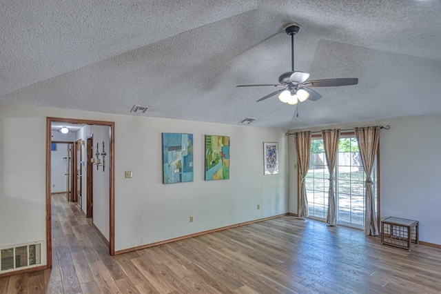 unfurnished room with a textured ceiling, light hardwood / wood-style flooring, ceiling fan, and vaulted ceiling