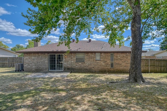 rear view of house featuring cooling unit