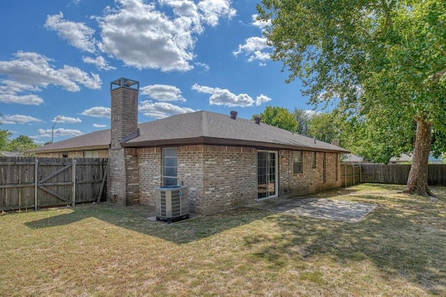 back of property featuring a yard, a patio area, and central air condition unit