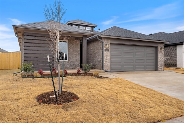 view of front of house featuring a garage and a front lawn